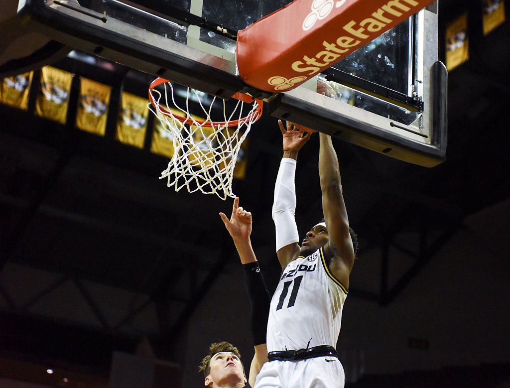 Mario McKinney Jr. leaps to dunk the ball